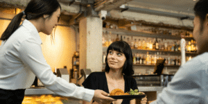 waiter handing food to the customer